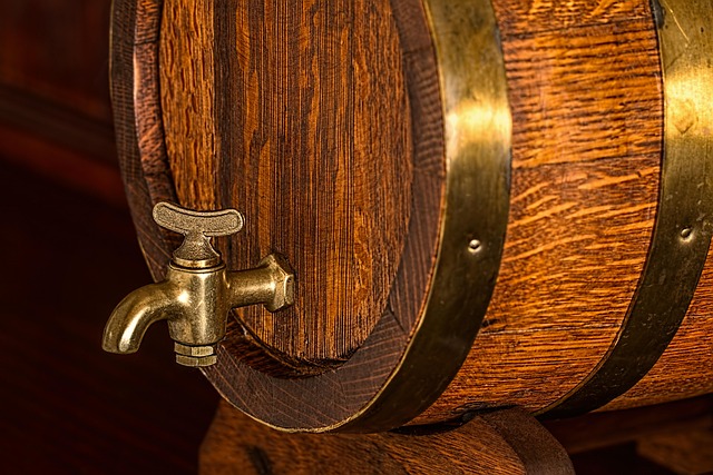 Wooden beer cask with a brass tap in warm pub light